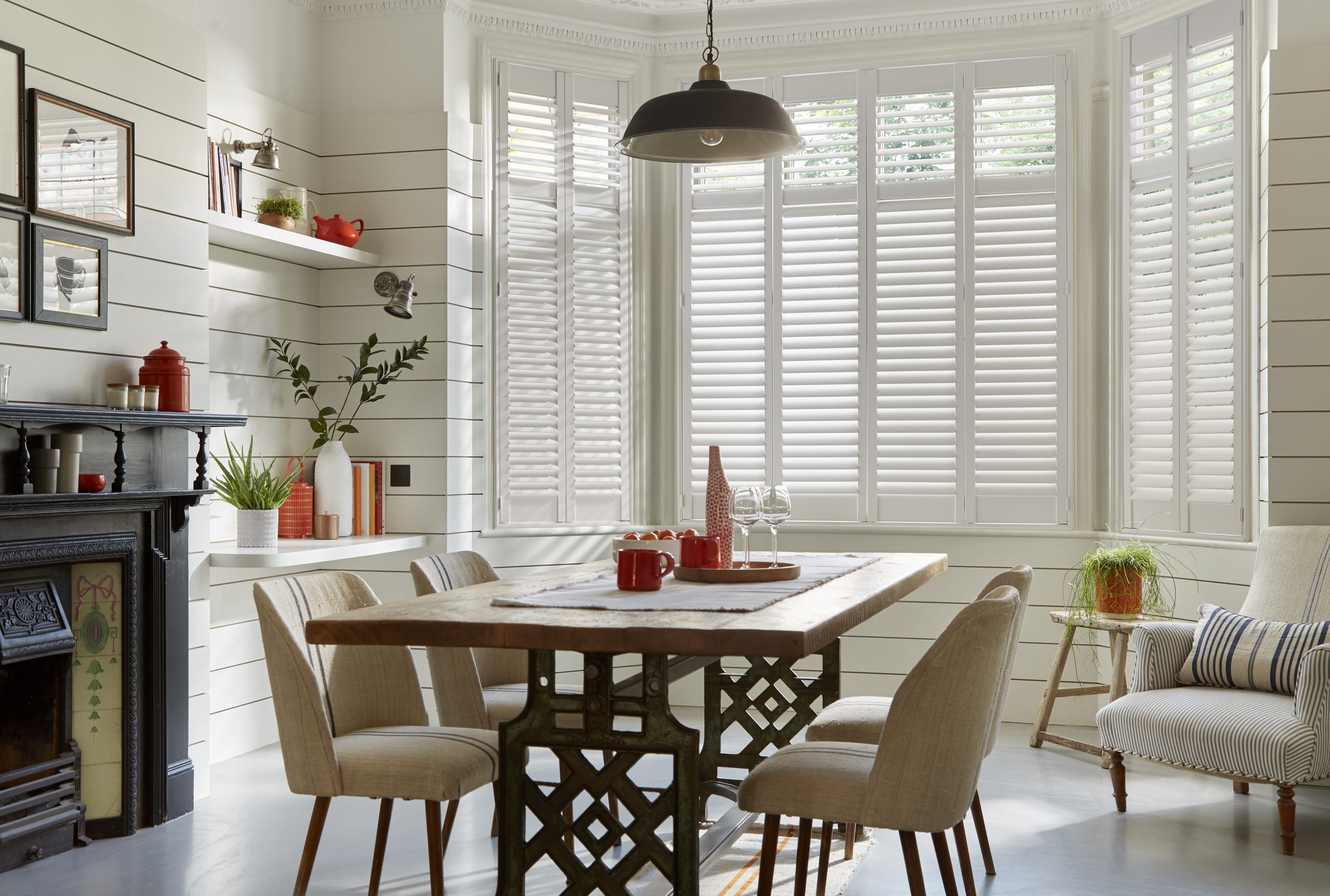 dining and living room with plantation shutters